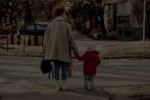 Mother and child crossing New York City street holding hands in casual brand Liberated People clothing. Click to enter LP casual clothing online store.